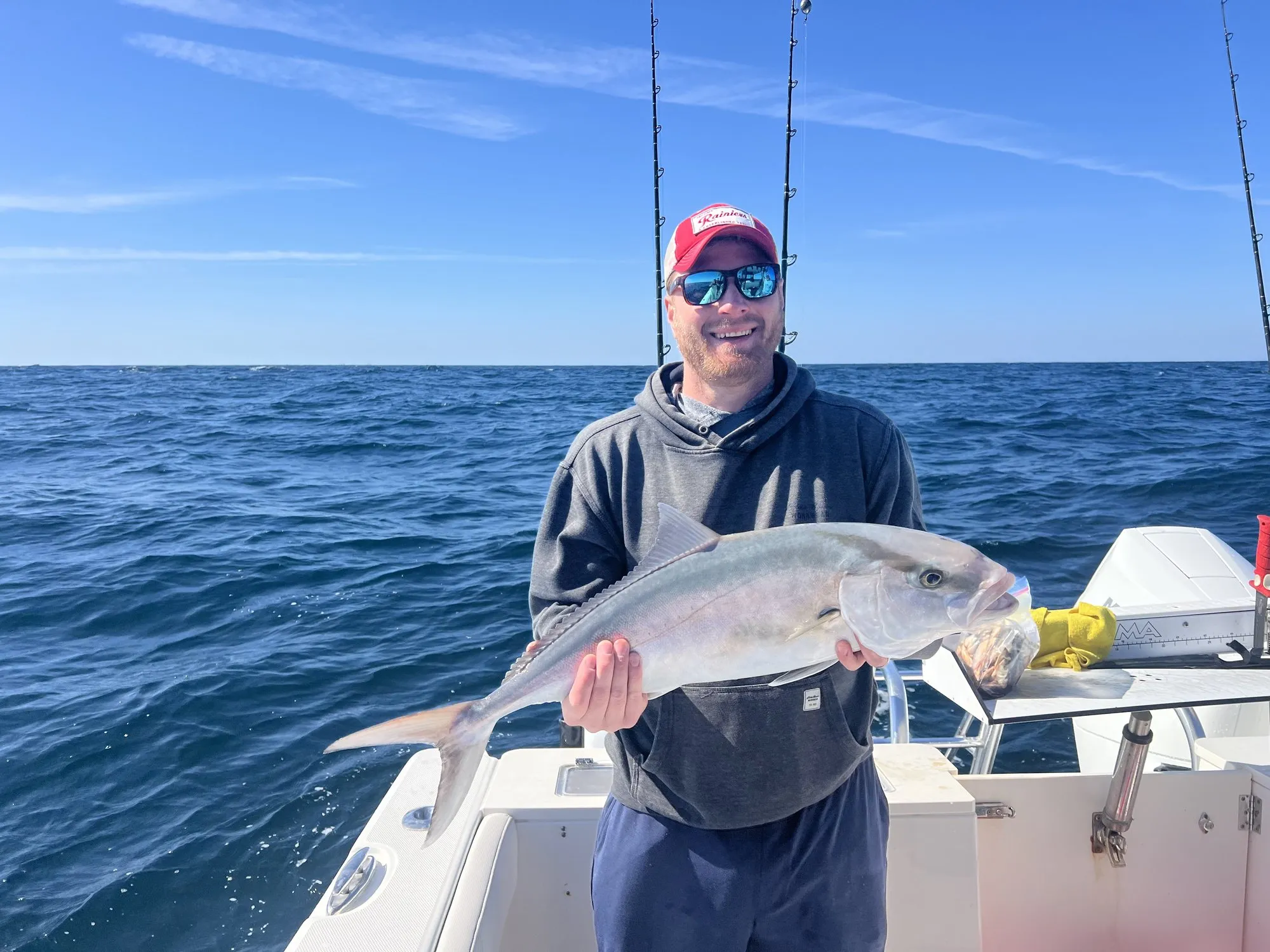 Angler holding an amberjack in the Gulf of Mexico aboard Phat Kat