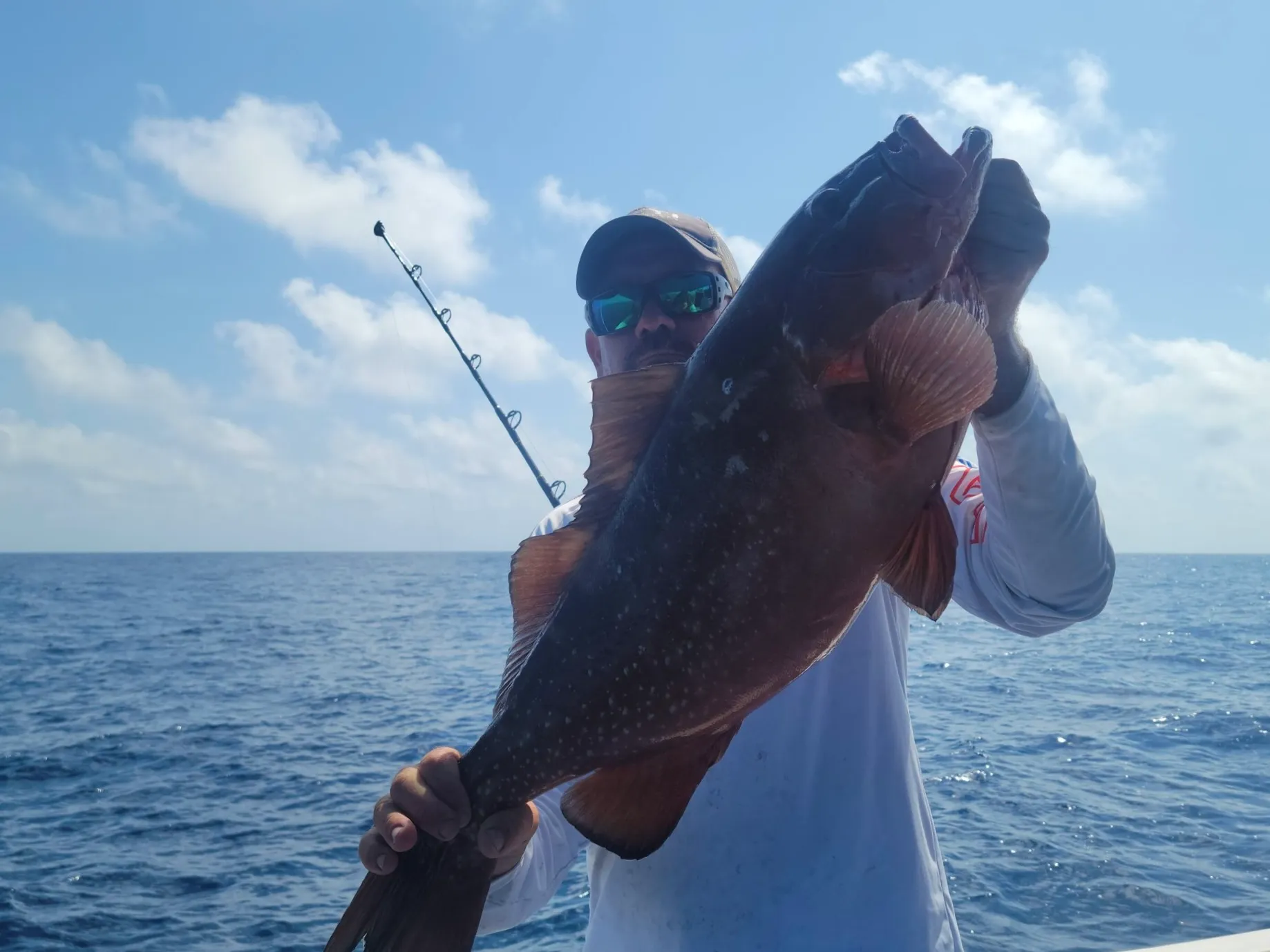 Captain Cuda holding a gag grouper aboard Phat Kat in the Gulf of Mexico