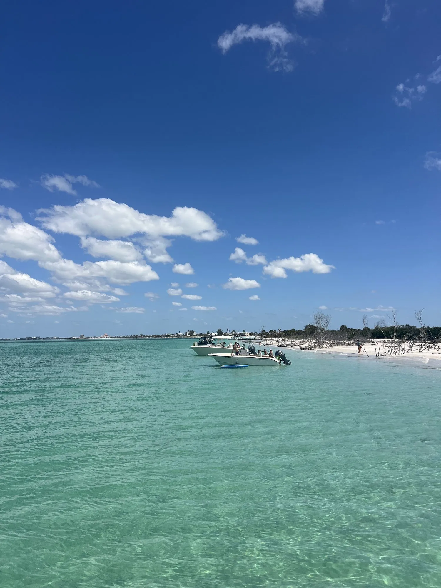 Boats anchored off the turquoise shoreline at Egmont Key