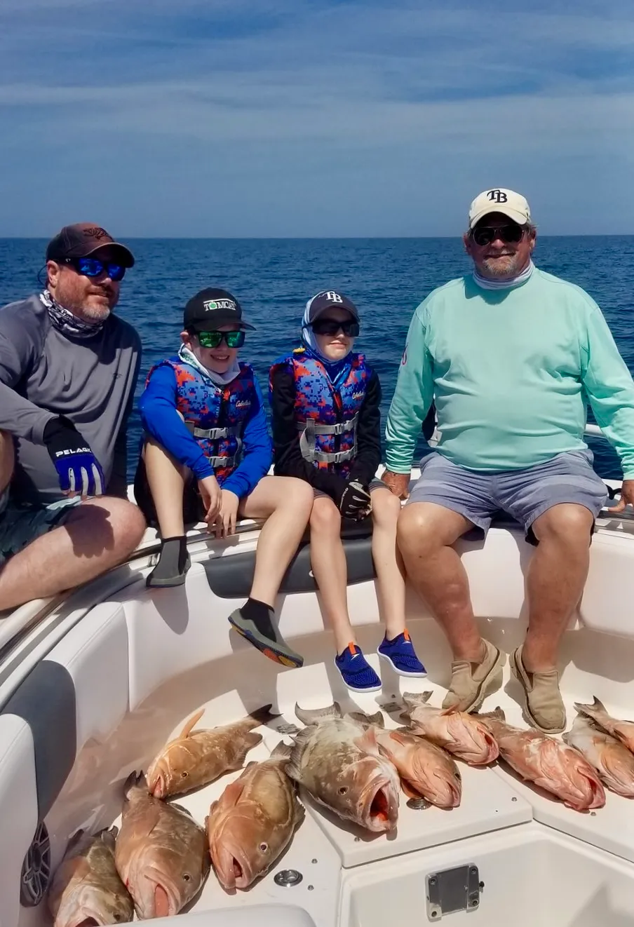 Family of anglers with a red snapper catch aboard Phat Kat in the Gulf of Mexico