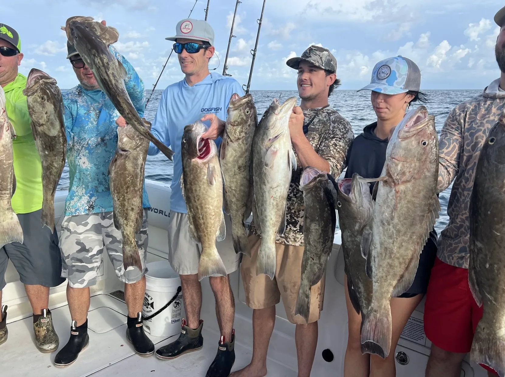 Charter group holding the catch of the day at the dock after a Gulf fishing trip from St. Pete