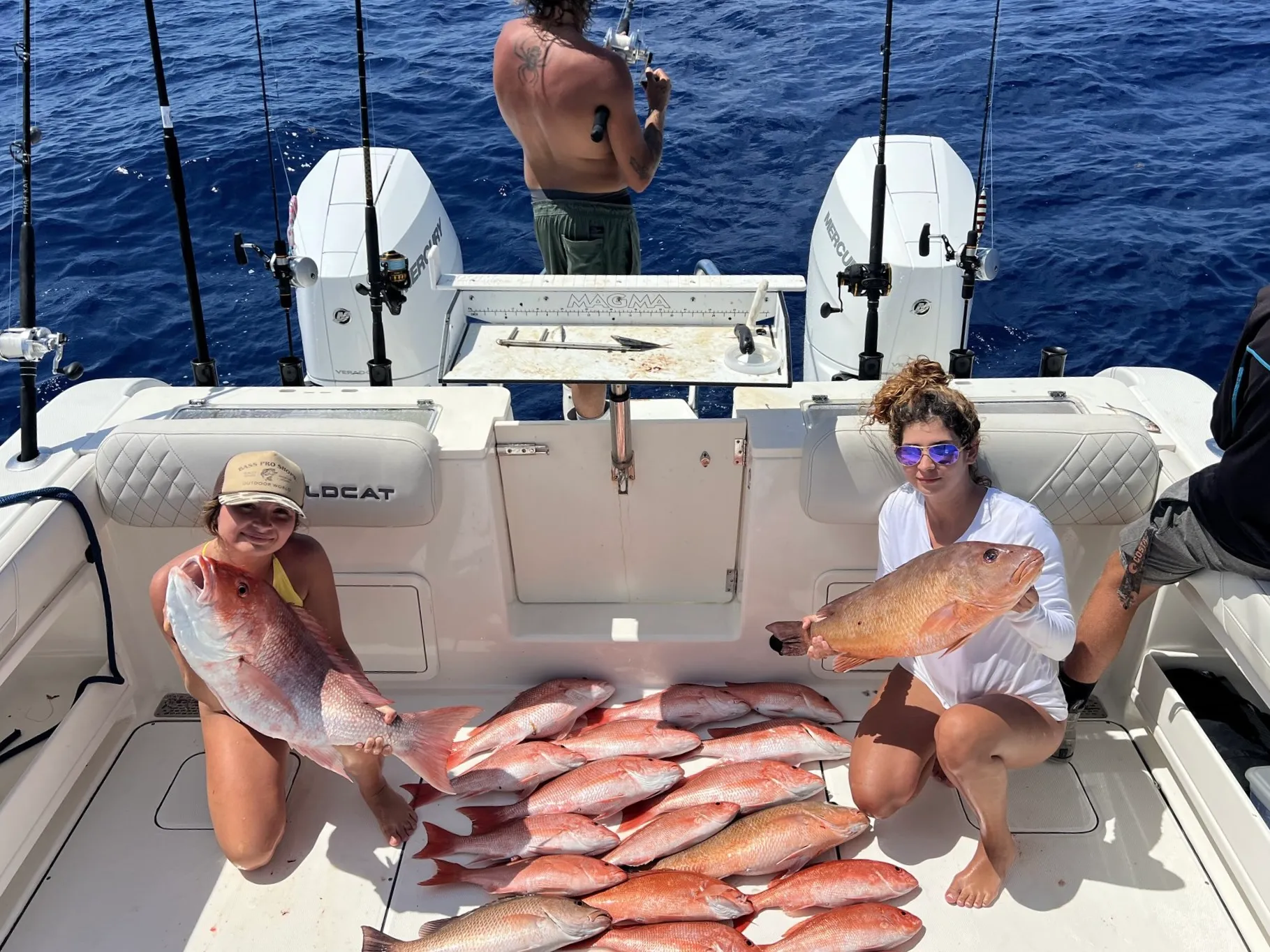 Charter group holding red snapper on the bow of Phat Kat in the Gulf of Mexico