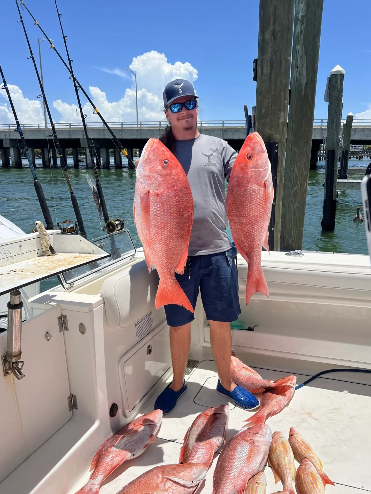 Guest holding a red snapper dockside after a Gulf fishing charter in St. Petersburg