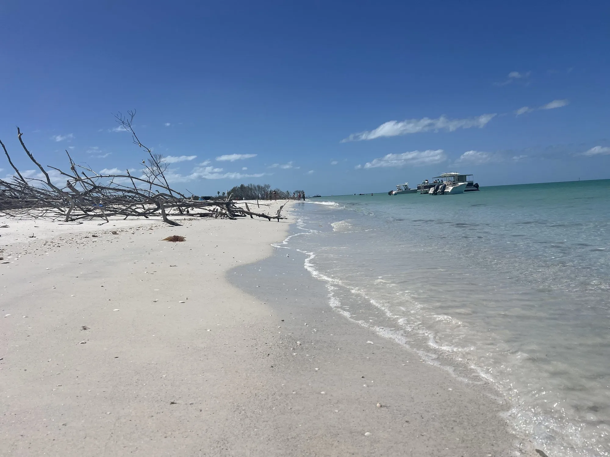 Quiet white-sand sandbar meeting clear, shallow Gulf water